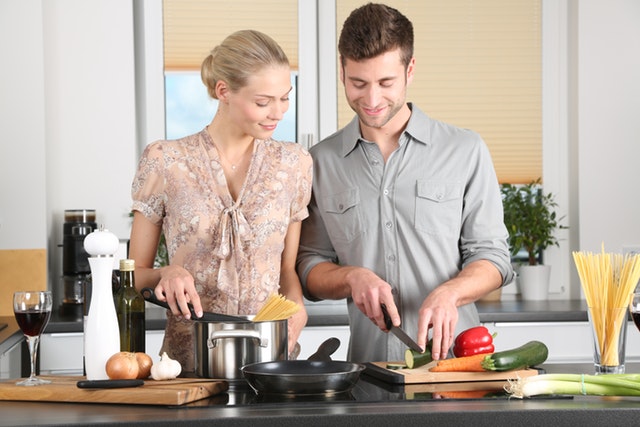 Happy couple preparing food