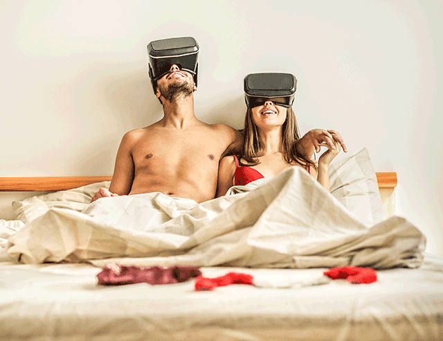 Couple on the bed in VR helmets